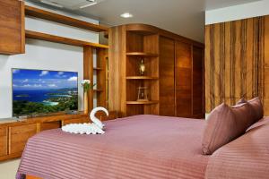 a bedroom with a bed with a white swan on it at NB Villa Vimana in Bang Rak Beach