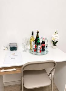 a white desk with bottles and glasses on it at Liam House - Stanza 2 in Limbiate