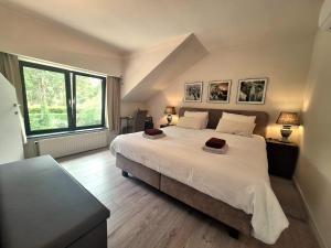 a bedroom with a large bed and a large window at Lakeview in Keerbergen +114 photos