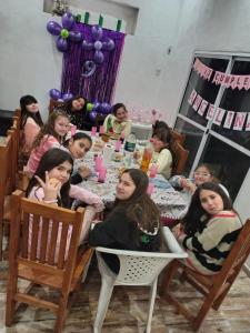 a group of children sitting around a table at Casa quinta oro verde in Oro Verde +12 photos