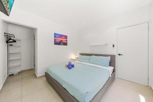 a bedroom with a bed with a toy on it at Villa Sirena Azul Apt 2 in Palm-Eagle Beach