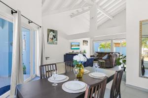 a dining room and living room with a table and chairs at Villa Sirena Azul Apt 2 in Palm-Eagle Beach