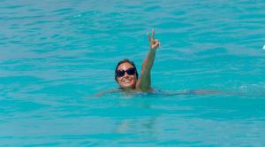 a woman in the water with her hand in the water at White Sand Maldives in Ukulhas