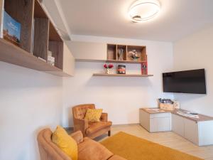 a living room with a couch and a tv at Bellanotte suite and dreams in Bellano