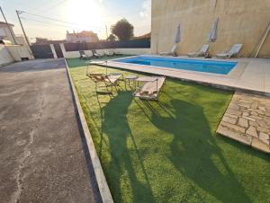 a shadow of a person standing next to a swimming pool at GuestHouse Relax & Pool in Esmoriz