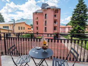 a table and chairs on a balcony with a building at Bellanotte suite and dreams in Bellano
