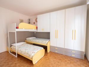 a bedroom with two bunk beds and white cabinets at Bellanotte suite and dreams in Bellano