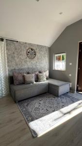 a living room with a couch and a rug at Domki na Wesołej 2 in Połczyno