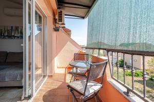 a balcony with a table and chairs on it at Maremy in Zadar