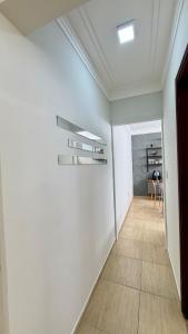 a hallway with white walls and a wooden floor at Espaço Primavera in Pouso Alegre