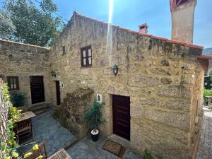 a stone house with a stone wall at Casas Serranas in Gouveia +28 photos