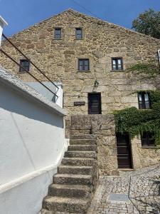a stone building with stairs in front of it at Casas Serranas in Gouveia