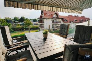 a wooden table with a potted plant sitting on a patio at B-Two10 in Balatonlelle