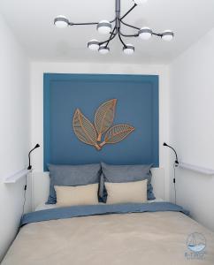 a bedroom with a blue headboard with a butterfly on it at B-Two10 in Balatonlelle