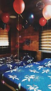 a room with two beds with balloons hanging from the ceiling at Saghbine bungalows in ‘Ayn Zubdah