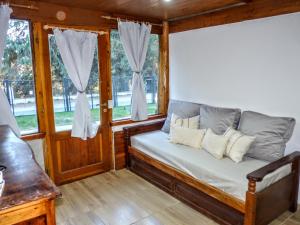 a bed in a room with windows at Carreño Andino in San Carlos de Bariloche