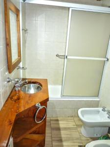 a bathroom with a sink and a shower and a toilet at Carreño Andino in San Carlos de Bariloche +10 photos