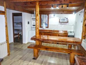 a kitchen with a wooden bench in a room at Carreño Andino in San Carlos de Bariloche