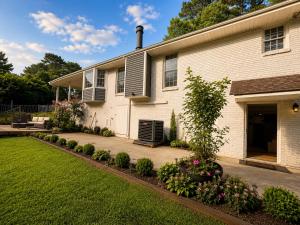 a house with a lawn in front of it at Elegant Boutique Stay in Lilburn