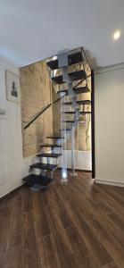 a glass staircase in a room with a stone wall at G & N Luxury House in Lecce