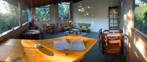 a wooden table and chairs in a restaurant at Kumaru Pousada e Restaurante in Palmeiras +2 photos