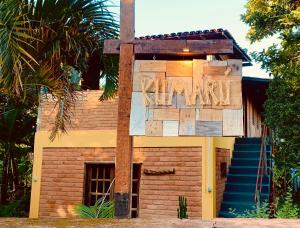 a brick house with a sign on the side of it at Kumaru Pousada e Restaurante in Palmeiras