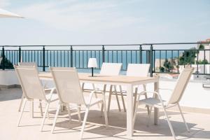a wooden table and chairs on a balcony at Laz Palace in Ulcinj +122 photos