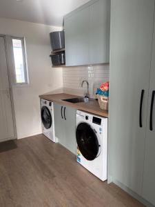 a kitchen with a washing machine and a sink at Carters Beach Escape in Carters Beach +5 photos