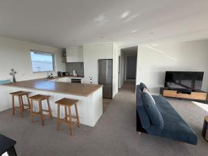 a kitchen and living room with a table and chairs at Carters Beach Escape in Carters Beach