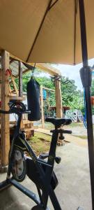 a bike parked under a tent with a bag on it at Red's Cafè & Resto- Glass Cabin in Manolo Fortich