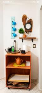 a shelf in a kitchen with a tea pot on it at Caelum House Familiar Con Cochera in Rafaela