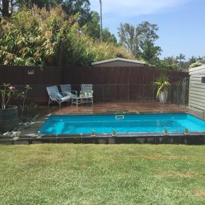 a swimming pool in the backyard of a house at Brodie Beach Bungalow in Coffs Harbour