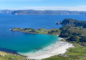 an aerial view of a beach and the ocean at Apartment in Måløy in Måløy