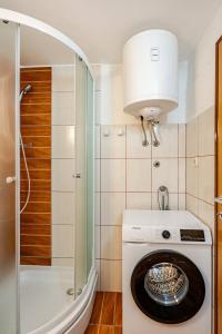 a white washing machine in a bathroom with a lamp at Maremy in Zadar +62 photos
