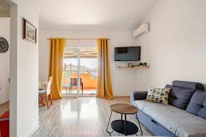a living room with a couch and a tv at Maremy in Zadar