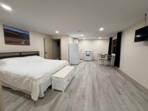 a bedroom with a bed and a table and a refrigerator at Alpine Adventures Inn in Alpine