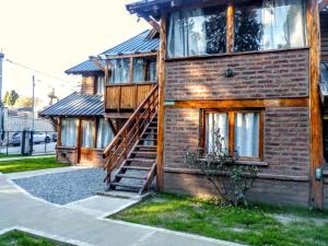 a brick house with a staircase on the side of it at Carreño Andino in San Carlos de Bariloche
