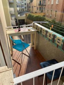 a balcony with a table and chairs on a balcony at CASA di Pi in Bologna +2 photos