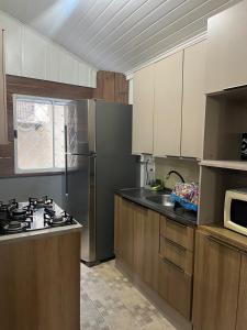 a kitchen with a sink and a stove top oven at 10 - Casa completa com piscina, Wi-Fi e Garagem in São Leopoldo +14 photos