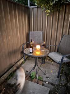 a table with two bottles of wine and a candle at Guest ensuite room with private entrance in Melbourne