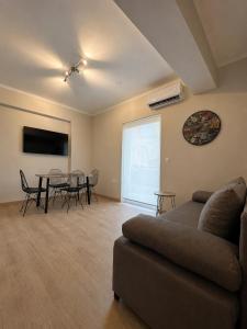 a living room with a couch and a table at Angelland Luxury Suites in Nafpaktos