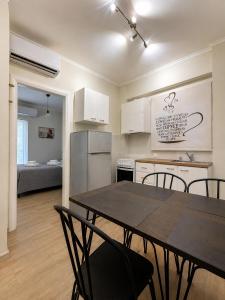 a kitchen and dining room with a table and chairs at Angelland Luxury Suites in Nafpaktos