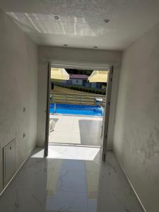 an empty room with a view of a swimming pool at Luksuzna kuća sa bazenom in Modriča +5 photos