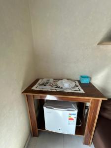 a small wooden table with a plate on it at Chez Bouchra Suite familiale in Pont Blondin