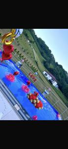 a large swimming pool with umbrellas in the water at Luksuzna kuća sa bazenom in Modriča