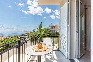 a balcony with a table and a view of the ocean at New Dhermi Icon 3 - Parking in Dhërmi