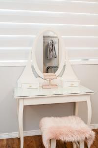 a white dressing table with a mirror and a pink rug at Fabulous Home-King bed-Easy Access to EVERyTHING! in Edmonton +24 photos