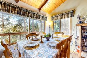 a dining room with a table and chairs and a window at Idyllic Cabin in the Woods: Cozy Crestline Retreat in Arrowhead Highlands