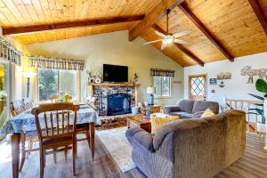 a living room with a table and a fireplace at Idyllic Cabin in the Woods: Cozy Crestline Retreat in Arrowhead Highlands