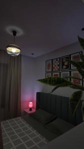 a bedroom with a bed and a pink light at Cozy Urban Nest in La Marsa +7 photos